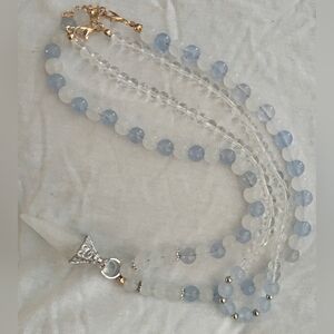 A double Necklace pairing aquamarine and quartz crystal beads with a Charm